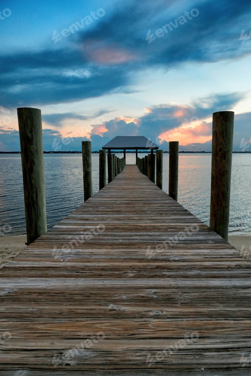 Preview: Wooden bridge in the sea under a cloudy sky during sunset - a cool picture for wallpapers