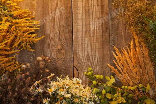Preview: top view of bunches of wildflowers and herbs on wooden surface