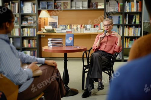 Preview: Senior Caucasian Woman Speaking during Session with Audience in Bookstore