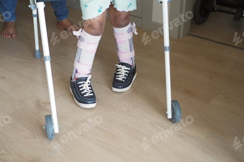 Preview: Young Child Using Walker for Supportive Mobility Indoors