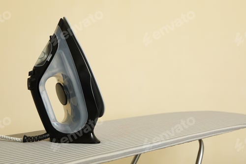Vista previa: Modern iron on ironing board, space for text