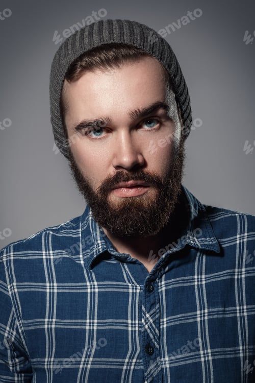 Preview: Portrait of handsome bearded man in checkered shirt