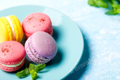 Preview: Colored macaroons. Delicious sweet colorful French desserts on light background