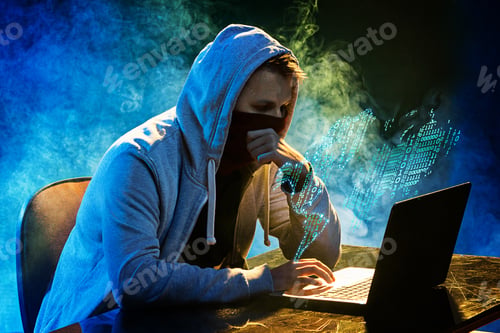 Preview: Hooded Computer Hacker Stealing Information With Laptop