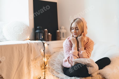 Preview: Pretty girl enjoying comfy armchair while dreaming of warm days