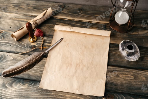 Preview: Quill pen and old paper sheet on wooden background