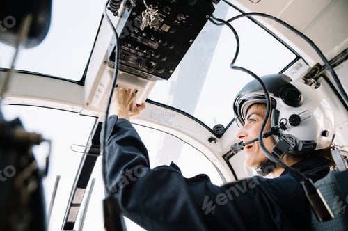 Preview: Attractive woman pilot sitting in the helicopter
