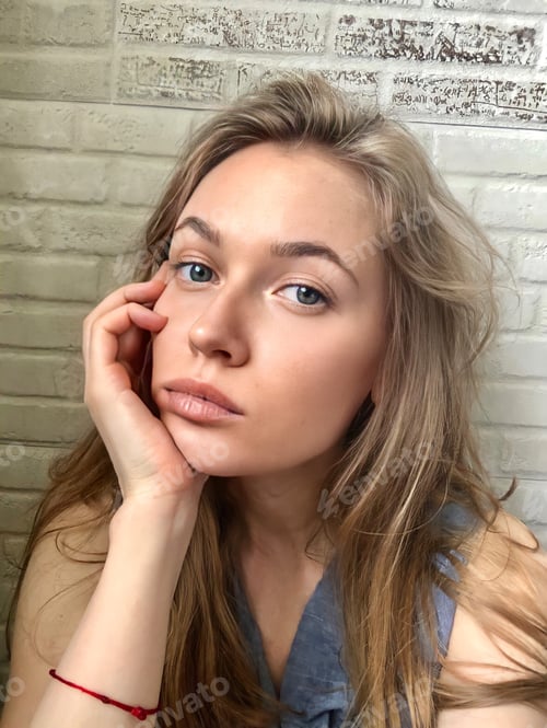 Preview: Blonde Woman Posing Indoors With Hand On Face