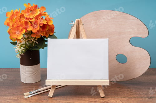 Preview: small wooden easel with blank canvas on wooden table