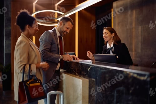Preview: Happy business couple checking in at the hotel.