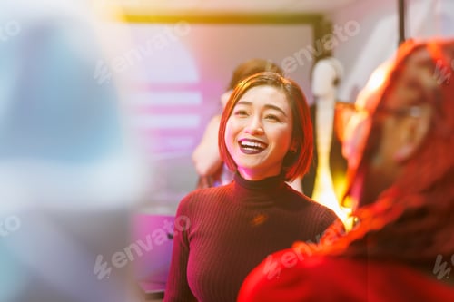 Preview: Happy asian woman partying in nightclub