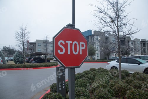 Preview: Stop sign covered in ice with parked cars and buildings