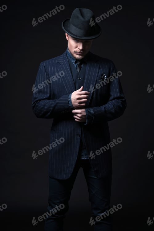 Preview: Retro 1900 Modern Fashion Man With Blonde Hair And Beard. Wearing Blue Striped Suit And Black Hat