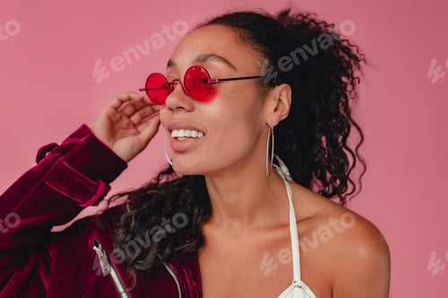 Preview: attractive black african american woman in stylish outfit on pink background