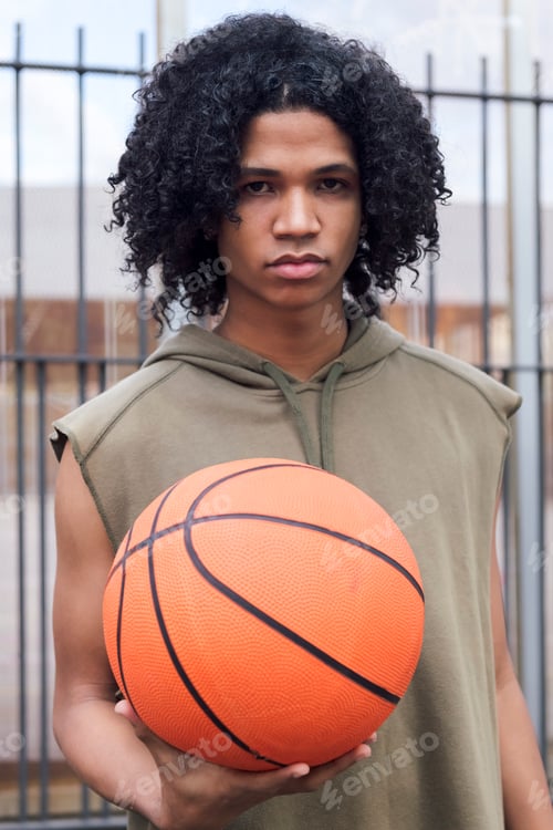Preview: african american teenager male holding basketball