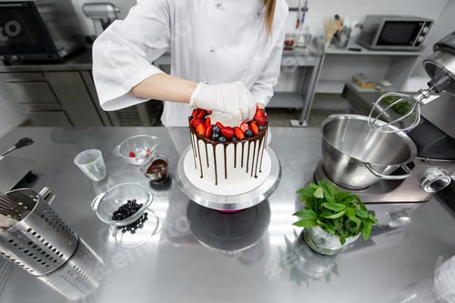 Preview: Pastry chef decorates the cake with chocolate streaks of strawberries and blueberries