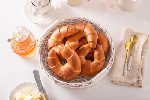 Preview: Golden and hot croissants with honey for breakfast.