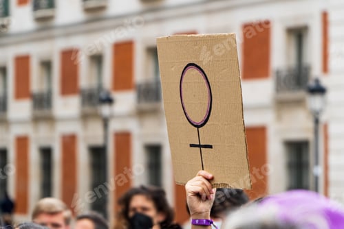 Preview: Crowd Holding Sign during a Public Gathering