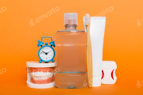 Preview: Mouthwash and other oral hygiene products on colored table top view