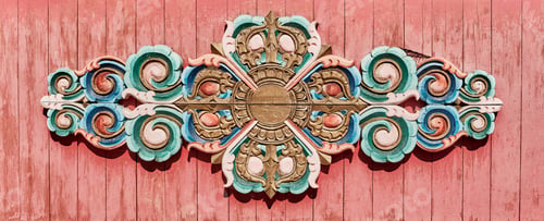 Preview: Buddhist floral colorful pattern carved from wood and painted. Decor on red plank wall of temple.