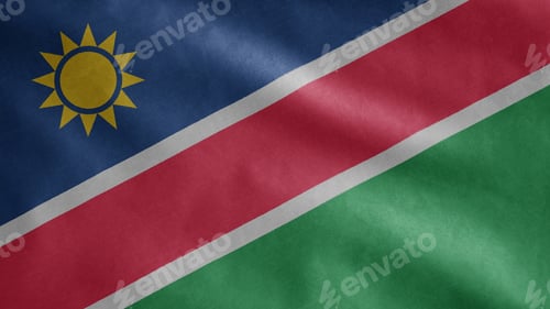Preview: Namibian flag waving in the wind. Close up of Namibia banner blowing soft silk.