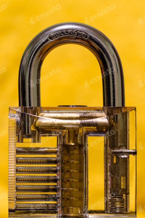 Preview: Closeup shot of a Visible Keyed Padlocks See Through Transparent isolated with a yellow background