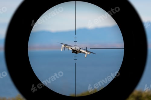 Preview: Gun sight pointing at a drone flying with the ocean in the background