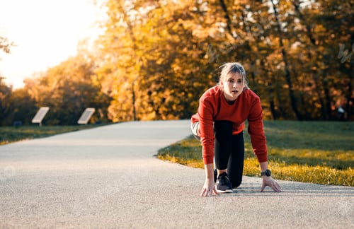 Preview: Young woman running in park.
