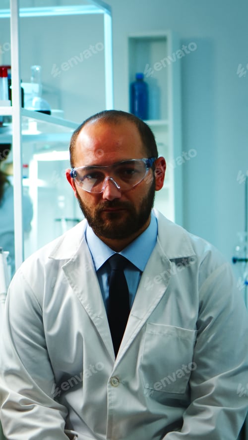 Preview: Tired doctor with glasses looking exhausted at camera