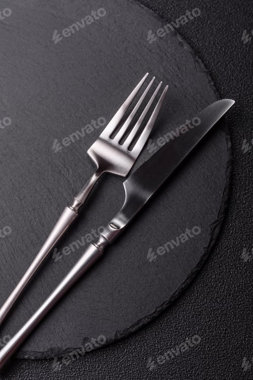 Preview: An empty slate cutting board with cutlery on a kitchen counter. Slate cutting board