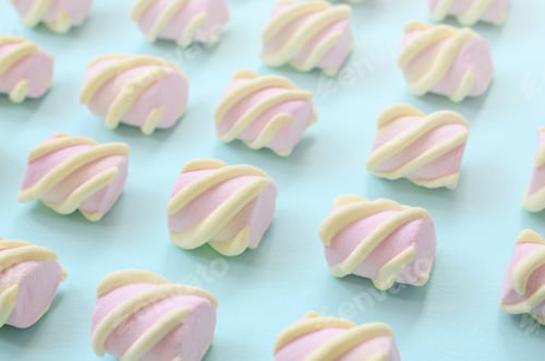 Preview: Colorful marshmallow laid out on blue paper background. pastel creative textured pattern