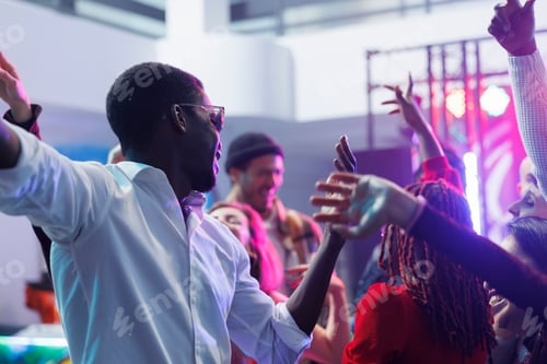Preview: Man taking selfie with friends in club