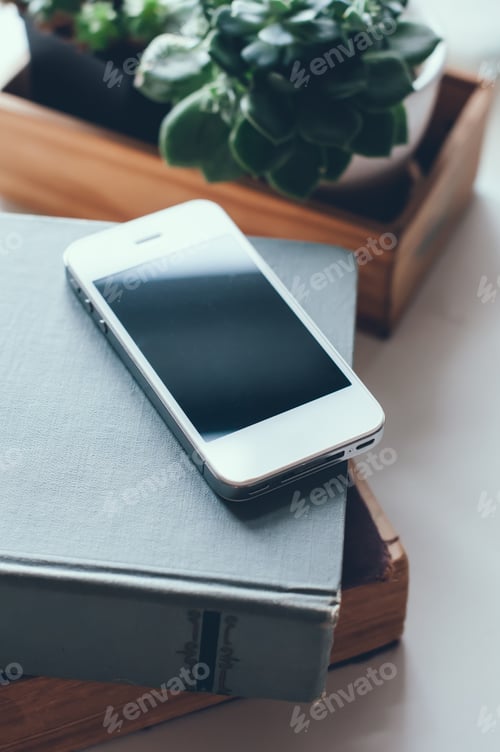 Preview: Old Vintage Books, Smartphone And Plants On A Table
