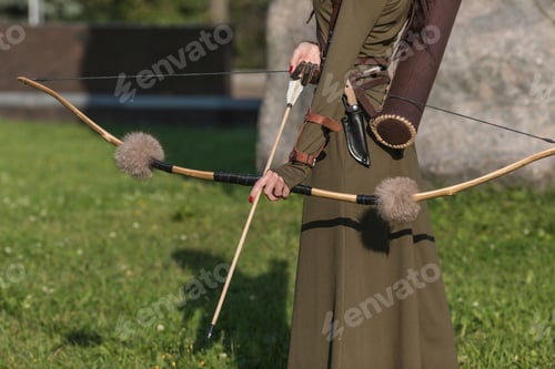 Preview: Bow and arrow in woman hands close-up