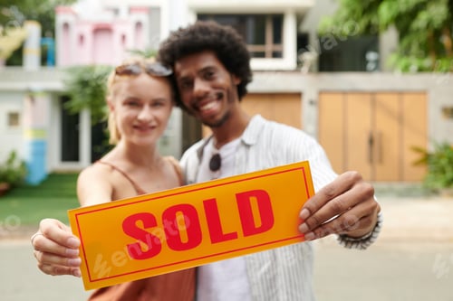 Preview: Sold Sign in Hands of Happy Couple