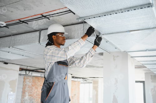 Preview: Construction worker installing ventilation system on building site