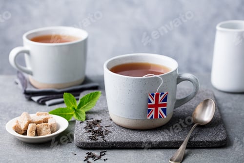 Preview: Tea in Mugs with British Flag Tea Bag Label. Grey Background. Close up.