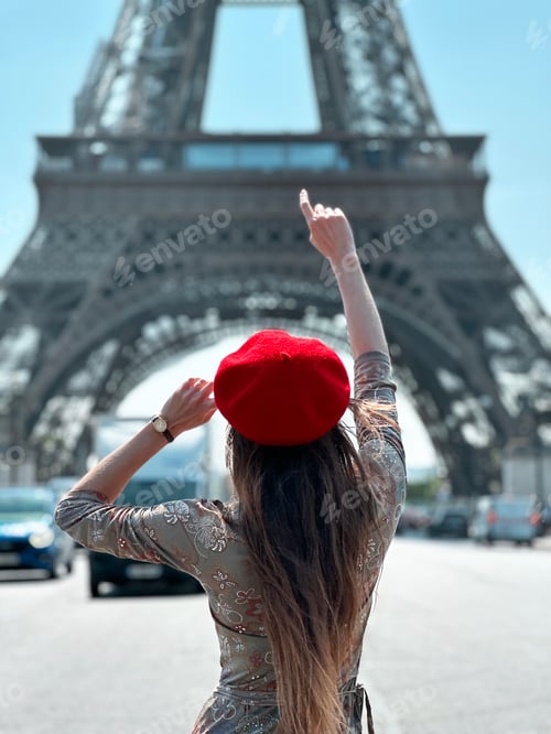 Preview: Young Woman With Long Hair Wearing Red Beret Wristwatch Standing in Front of Eiffel Tower in Paris