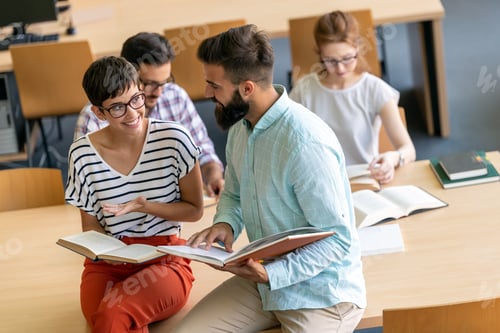 Preview: Happy university students studying with books in library. Group of multiracial people in college