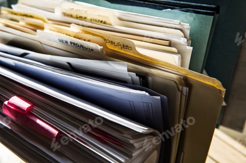 Preview: Close-up of files and file folders on a desk top in an office.