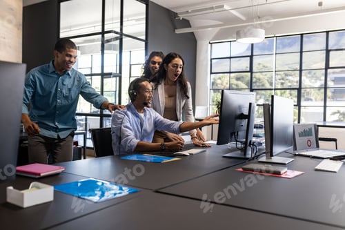 Preview: Diverse business team collaborating and discussing project at modern office desk