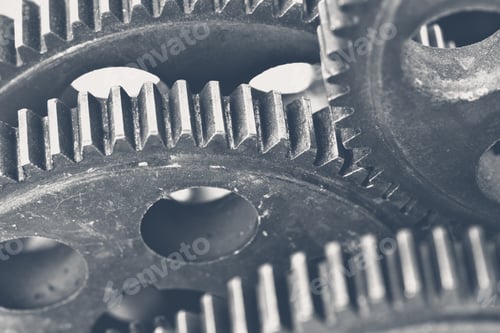 Preview: Close up view of interlocked metal gears showing intricate details and texture in machinery parts