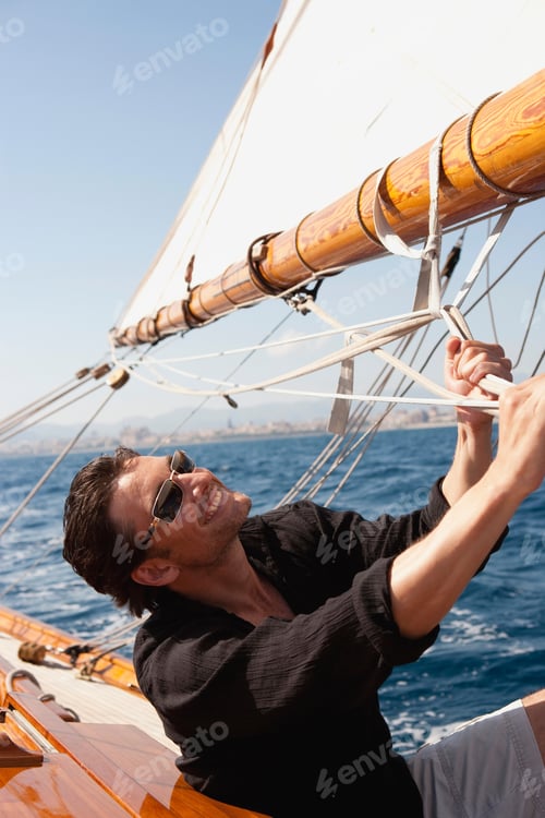 Preview: man holding on to ropes on deck