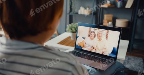 Preview: Young Asia girl using laptop video call meeting talk with elderly family.