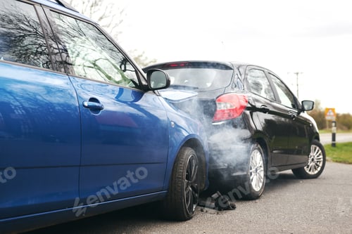 Preview: Two Damaged Cars Involved In Road Traffic Accident Showing Smoke After Collision