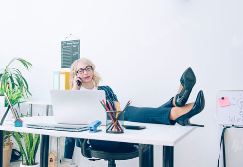 Preview: Businesswoman talking on the phone crossed sexy legs with high heels on a desk in the office.