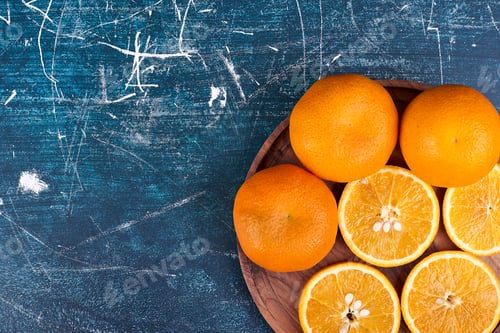 Preview: Sliced oranges and mandarines on a wooden platter in the bottom corner