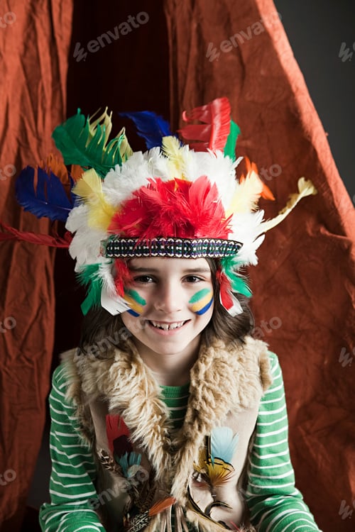 Preview: Young child smiling in colorful feathered headdress