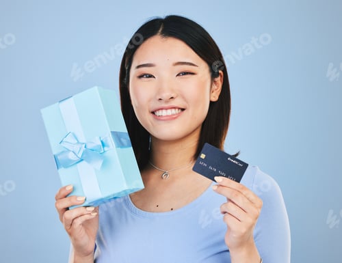 Preview: Woman, credit card and gift box, prize or retail giveaway and payment in portrait and a blue backgr