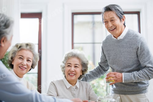 Preview: Happy senior friends talking and drinking tea